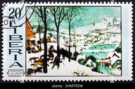 LIBERIA - UM 1969: Eine in Liberia gedruckte Marke zeigt Jäger im Schnee, Gemälde von Pieter Bruegel dem Älteren, niederländischer Maler, um 1969 Stockfoto