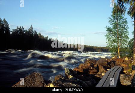 Wilde Stromschnellen im Land im Jahr 2005, analog. Die Holzbrücke, Fußgängerbrücke durch den einfachen Teil des Flusses. Stockfoto