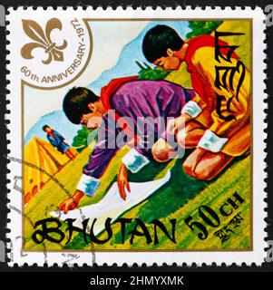 BHUTAN - UM 1971: Eine in Bhutan gedruckte Briefmarke zeigt die Pfadfinderkarte, 60th Jahrestag der Pfadfinder, um 1971 Stockfoto