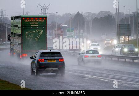 Dundee, Tayside, Schottland, Großbritannien. 13th. Februar 2022. UK Wetter: Nordostschottland erlebt leichte Winde und sintflutartige Regengüsse mit Temperaturen bis zu 7 Grad Sonntagfahrer auf der vielbefahrenen Dundee Kingsway West-Schnellstraße stehen vor gefährlichen und nassen Bedingungen. Kredit: Dundee Photographics/Alamy Live Nachrichten Stockfoto