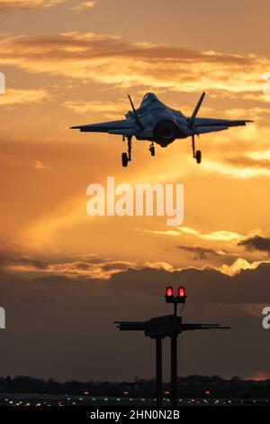 Lockheed Martin F-35A Blitz II der US-Luftwaffe landete in den Sonnenuntergang bei RAF Lakenheath. Stockfoto