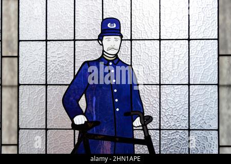 Buntglasfenster mit einem viktorianischen Polizisten und einem Fahrrad im Polizeimuseum von Vancouver Stockfoto
