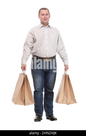 Gut aussehender junger Mann mit Einkaufstaschen Stockfoto