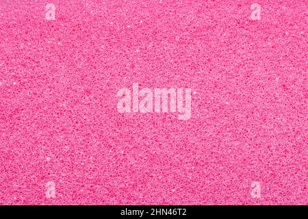 Pinke Schwammstruktur. Nahaufnahme eines schönen flauschigen rosa Kosmetik-Schwamm für Hintergrund. Makrofotografie. Stockfoto