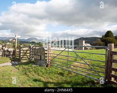 Fußwegschild und Tor, das nach St. Michael und alle Angels Church Hawkshead der Lake District Cumbria England führt Stockfoto