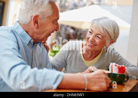 Der Ruhestand gab ihnen mehr Zeit, sich gegenseitig Gesellschaft zu genießen. Aufnahme eines älteren Paares, das in einem Café Kaffee getrunken hat. Stockfoto