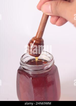 Honig im Glas, weißer Hintergrund Stockfoto