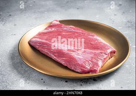 Rohes, marmoriertes Rindfleisch-Steak auf dem Fleischtisch. Grauer Hintergrund. Draufsicht Stockfoto