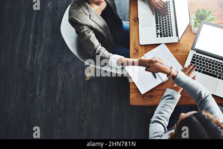 Lassen Sie uns unsere Talente zusammenführen, wenn wir an die Spitze kommen. Aufnahme von zwei Geschäftsfrauen, die sich in einem Büro die Hände schüttelten. Stockfoto