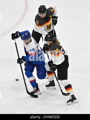 Peking, China. 15th. Februar 2022. Olympische Spiele, Eishockey, Viertelfinale, Slowakei - Deutschland im National Indoor Stadium greifen Fabi Wagner (r/bottom) und Korbinian Holzer (r/top) von Deutschland Milos Roman von der Slowakei an. Kredit: Peter Kneffel/dpa/Alamy Live Nachrichten Stockfoto