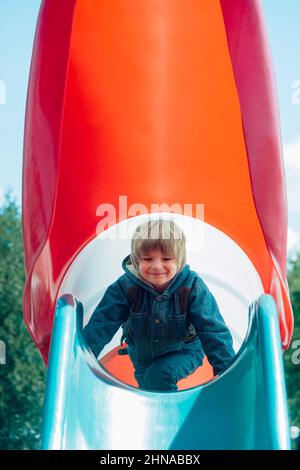 Happy Kid auf der Rutsche Stockfoto