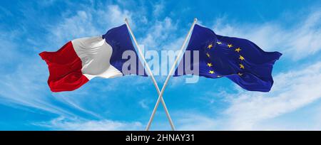 Gekreuzte Nationalflaggen Frankreichs und die Flagge der Europäischen Union, die bei bewölktem Himmel im Wind wehte. Symbolisieren von Beziehung, Dialog, Reisen zwischen tw Stockfoto