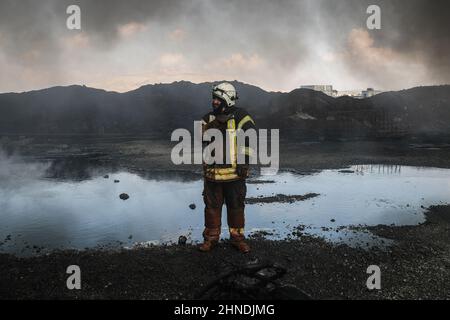 Dana, Syrien. 16th. Februar 2022. Mitglieder der syrischen Zivilverteidigung stehen an einem Treibstoffdepot, in dem ein Feuer ausbrach, das als Ergebnis eines Raketenangriffs des syrischen Regimes und russischer Streitkräfte auf das Dorf Tarminin in der Nähe der Stadt Dana ausbrach. Nach Angaben der Weißhelme wurden bei einem Artilleriebeschuss auf einem Brennstoffmarkt, der angeblich einer dschihadistischen Gruppe angehört, vier Zivilisten getötet und zwei weitere verletzt. Quelle: Anas Alkharboutli/dpa/Alamy Live News Stockfoto