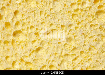 Gelber Schwamm strukturierter Hintergrund. Hintergrund aus Schaumgummi. Stockfoto