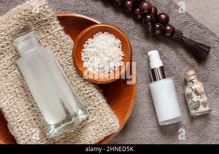 Fermentiertes Reiswasser und verschiedene Zutaten und Komponenten für Wellness- und Verjüngungskuren. Nahaufnahme, Draufsicht, Platz für Text, Nachbau Stockfoto