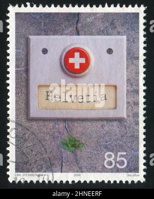 SCHWEIZ - UM 2004: Briefmarke gedruckt von der Schweiz, zeigt Türklingelknopf, um 2004 Stockfoto