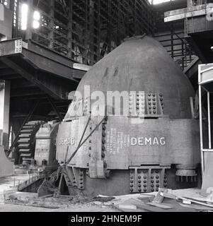 1950s, historisch, ein in Deutschland gemachter Demag metallurgischer Bessemer-Verarbeiter oder -Ofen bei The Abbey Works, Port Talbot, Wales, Großbritannien. Nach WW2 wurde die Steel Company of Wales (Scow) gegründet, um einen modernen integrierten Stahlkomplex auf dem ehemaligen Margam Iron & Steel-Werk zu schaffen. Das Abbey Works wurde 1951 eröffnet und bis 1953 vollständig in Betrieb genommen. Es war das größte Stahlwerk in Europa. Es wurde 60s eröffnet. Im Jahr 1967 verstaatlicht, wurde es ein Teil von British Steel. Im Jahr 2000 zurück in Privatbesitz mit Corus, die 2007 von der indischen Tata Group übernommen wurde. Stockfoto