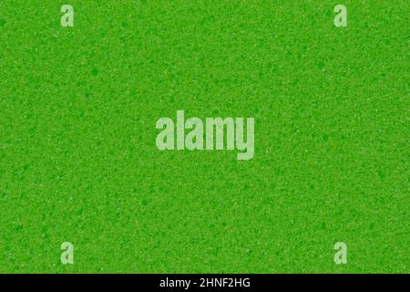 Textur eines Schaumspülschwamms. Hintergrund des grünen Schwamms zur Reinigung. Stockfoto