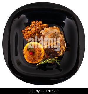 Schweinesteak, Linsen, gegrillte Orange Stockfoto