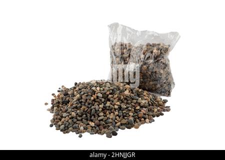 Bunte Kieselsteine in Plastiktüten für Dekorationsarbeiten im Handwerksbetrieb. Gepackte farbige Kieselsteine. Landschaftsdesign. Stockfoto