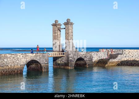 Junge Leute schwimmen gerne im Schloss Castillo de San Gabriel in Arrecife Stockfoto