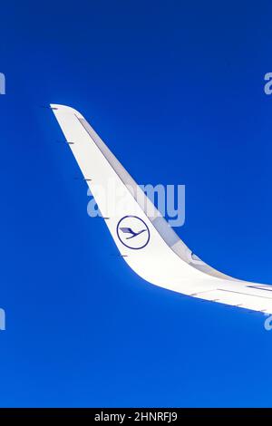 Linker Flügel der Lufthansa-Flugzeuge am blauen Himmel Stockfoto