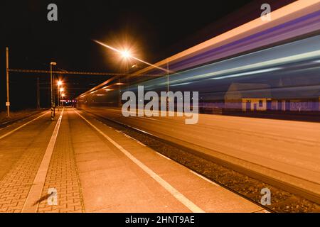 Leichte Spur des Expresszuges im Bahnhof in der Nacht. Bahnsteig A in der Nacht Stockfoto