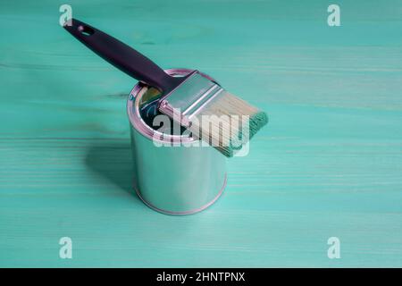 Pinsel mit der grünen Farbe liebt auf der Farbkann Stockfoto