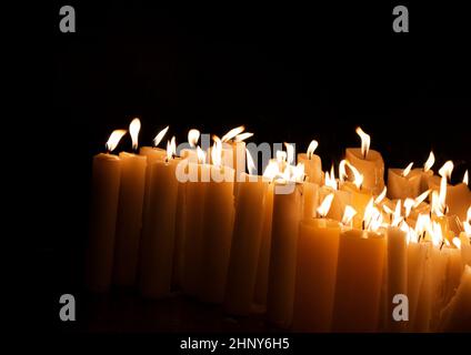 Kirchliche Kerzen in Dunkelheit Stockfoto