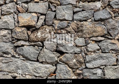 Mauer aus Ziegeln in vulkanischen Stein, nützlich für den Hintergrund. Stockfoto