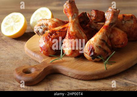 Gegrillte Hähnchenschenkel auf Schneidebrett. rustikales Abendessen Hintergrund. Stockfoto