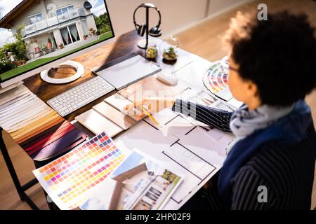 Seitenansicht von Immobilien Designer Arbeiten am Computer im Büro Stockfoto