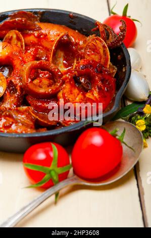 frische Meeresfrüchte-Eintopf zubereitet auf eine eiserne Pfanne Ove weißen rustikalen Holztisch Stockfoto