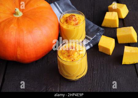 Kürbis-Smoothie mit Gewürzen auf Holzhintergrund Draufsicht. Speicherplatz kopieren . Stockfoto