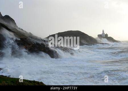 Sturm Eunice an den Mumbles. Swansea, Wales, Großbritannien. Die Wellen schlagen über Leuchtturm und Landzunge, während 90mph Winde das Spray aufwirbelten und die Brandung die Klippen verschlingt Stockfoto