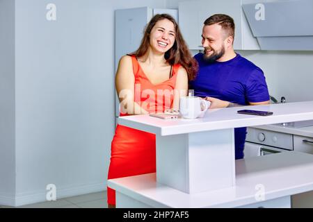 Junge Frau flirtet mit Kollegen in der Büroküche. Stockfoto