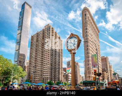 Blick auf ein Madison-Gebäude, das Flatiron-Gebäude und die gusseiserne Straßenuhr vor dem Toys Center im Madison Square, Manhattan. Stockfoto