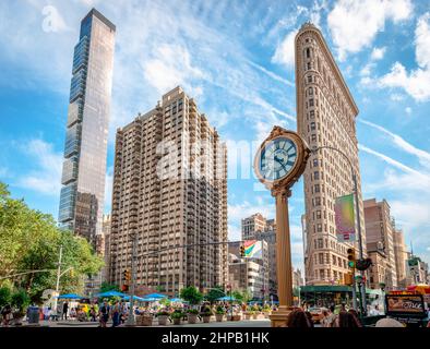 Blick auf ein Madison-Gebäude, das Flatiron-Gebäude und die gusseiserne Straßenuhr vor dem Toys Center im Madison Square, Manhattan. Stockfoto