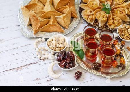 Ramadan Kareem festlich, Fasten, Halal-Essen. Ramadan-Menü: Gemischtes arabisches Pfannkuchen-Katayef und Datteln, Pistazie. Speicherplatz kopieren. Stockfoto