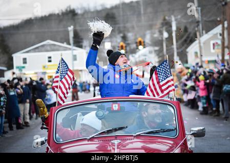 Richmond, USA. Ryan Cochran-Siegle, der Silbermedaillengewinnerin des Ski-Super-G im alpinen Skilauf bei den Olympischen Spielen in Peking, wird nach Richmond, VT, (ca. 4.000 Einwohner), begrüßt, indem er die Massen bei seiner Rückkehr aus China nach Vermont anfeuert. 19 2022 VT, USA. Seine Mutter, Barbara Ann Cochran, die olympische Goldmedaillengewinnerin im Slalom in Sapporo 1972, fährt auf dem Beifahrersitz (links). Die Familie Cochran führte jahrzehntelang ein kleines lokales alpines Skigebiet in Richmond, wo Ryan zum ersten Mal Ski fuhr. Es ist jetzt eine gemeinnützige Organisation. Kredit: John Lazenby/Alamy Live Nachrichten Stockfoto