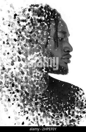 Ein Profilporträt eines Mannes kombiniert mit schwarzen Tintenspritzern. Paintographie. Stockfoto