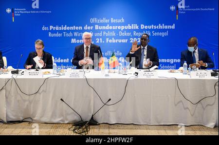 21. Februar 2022, Senegal, Dakar: Bundespräsident Frank-Walter Steinmeier (2nd v.l.) und Macky Sall (2nd v.r.), Präsident Senegals, zusammen mit Anja Hasduk (l, Bündnis 90/die Grünen), Staatssekretärin im Bundesministerium für Wirtschaft und Klimaschutz, Und Amadou Hott (r), Wirtschaftsminister des Senegal, nehmen an einer Diskussion mit Vertretern der Wirtschaft und Mitgliedern der Wirtschaftsdelegation Teil, die mit ihnen reisen. Präsident Steinmeier ist zu einem dreitägigen Besuch in der Westafrikanischen Republik Senegal. Foto: Bernd von Jutrczenka/dpa Stockfoto