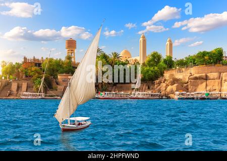 Ein Segelboot im Nil in der Nähe der koptisch-orthodoxen Kathedrale des Erzengels Michael, Assuan, Ägypten Stockfoto