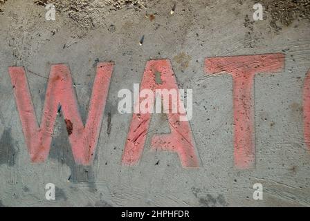 Wort Wat verblasste Schild auf Bürgersteig gemalt, Dubrovnik, Kroatien. Stockfoto