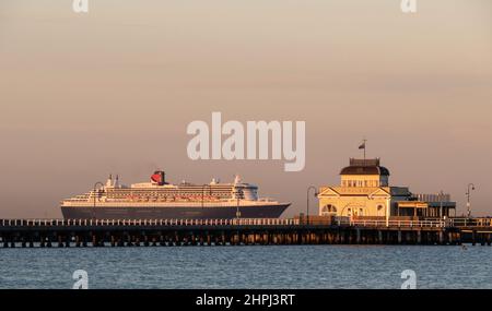 Das RMS Queen Mary 2 passiert den St. Kilda Pier an der Port Phillip Bay, Melbourne, Australien. Stockfoto