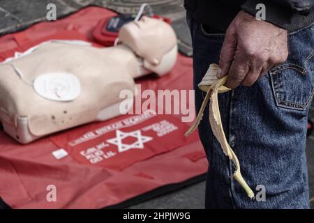 Jerusalem, Israel. 22nd. Februar 2022. Sanitäter von Magen David Adom, Israels führendem Rettungsdienst, demonstrieren und unterweisen am 22nd. Februar auf dem Shuk Mahane Yehuda Markt den Einsatz von HLW und Defibrillatoren und ihre Bedeutung für die Rettung von Menschenleben. Tausende von Defibrillatoren sind landesweit installiert und für den Einsatz an öffentlichen Orten verfügbar. Kredit: Nir Alon/Alamy Live Nachrichten Stockfoto