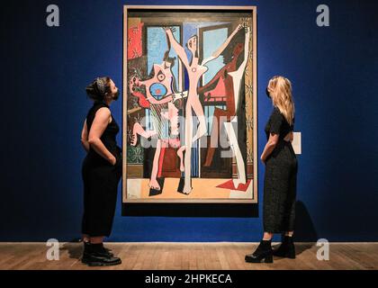 London, Großbritannien. 22nd. Februar 2022. Mitarbeiter posieren mit Pablo Picasso, Les Trois Danseuses, 1925. Surrealismus jenseits der Grenzen ist eine wegweisende Ausstellung, die zeigen soll, wie Künstler auf der ganzen Welt und über 50 Jahre hinweg vom Surrealismus inspiriert und vereint wurden. Es läuft in der Tate Modern vom 24. Februar - 29. August 2022. Kredit: Imageplotter/Alamy Live Nachrichten Stockfoto