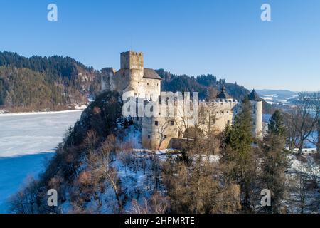 Polen. Mittelalterliche Burg in Niedzica, aus dem 14th. Jahrhundert (obere Burg) im Winter. Gefrorener künstlicher Czorsztyn-See auf dem Dunajec-Fluss Stockfoto