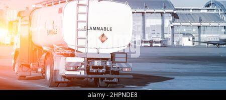 Rückansicht kleiner moderner Tankwagen, der auf dem Rollweg des Flugplatzes zum Betanken von Flugzeugen fährt. Zisterne LKW Luftfahrt Benzin. Gasversorgung des Flugzeugs Stockfoto