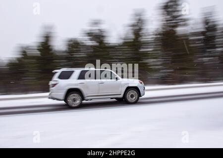 Reno, Usa. 22nd. Februar 2022. Ein SUV fährt auf einer schneebedeckten Straße. Die winterlichen Straßenverhältnisse verschlechtern sich, da Schnee in den Bergen fällt. Bei allen Fahrzeugen außer dem 4-Rad-Antrieb mit Schneereifen Ketten, sofern erforderlich. Kredit: SOPA Images Limited/Alamy Live Nachrichten Stockfoto